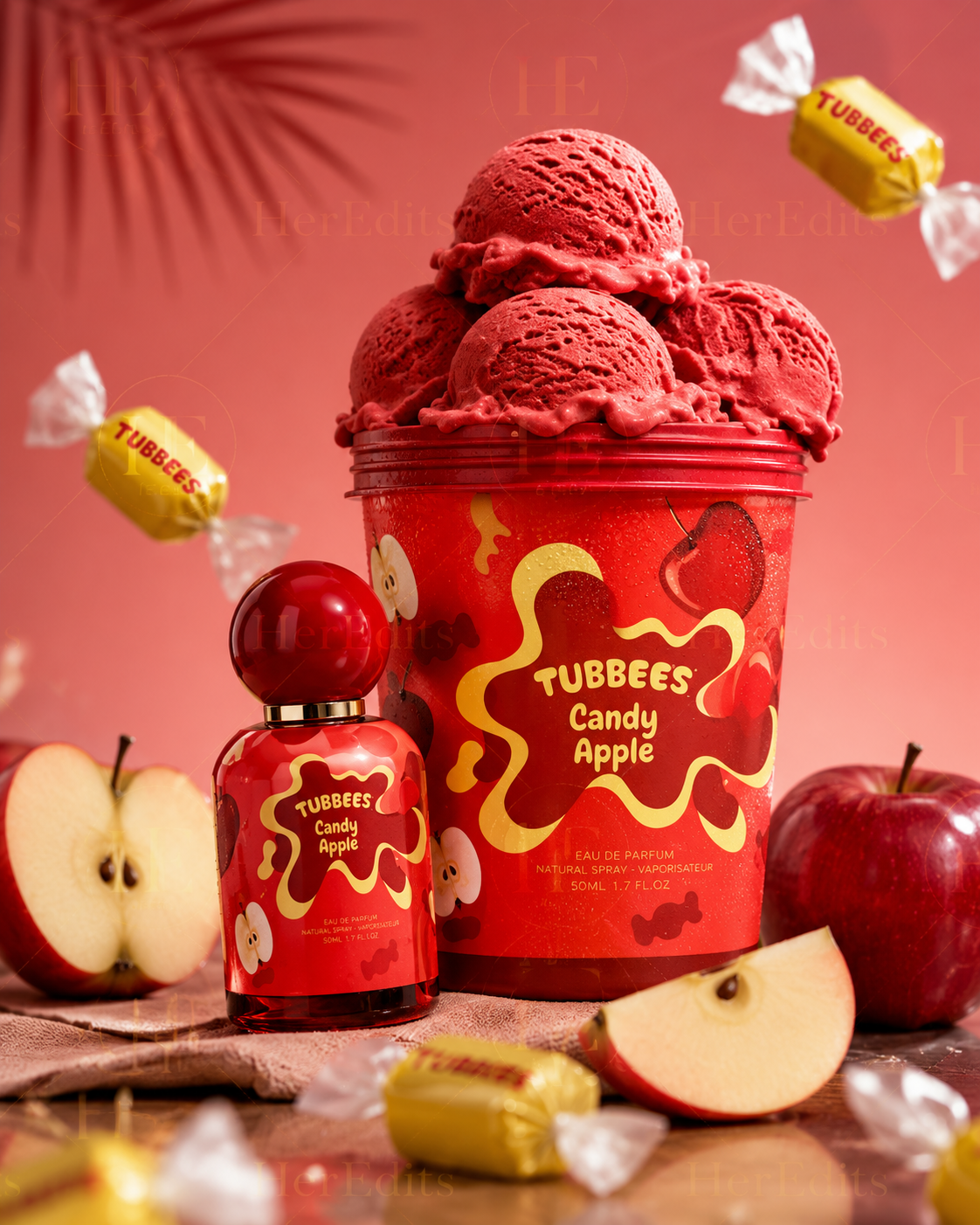 A red tub of Scoopz Candy Apple ice cream with scoops of red ice cream piled on top, alongside a matching red bottle of Tubbees Candy Apple fragrance, surrounded by red apples and wrapped candies on a pink background.
